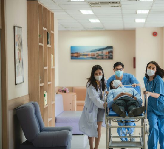 Medical team transporting a patient on a hospital stretcher during emergency care.