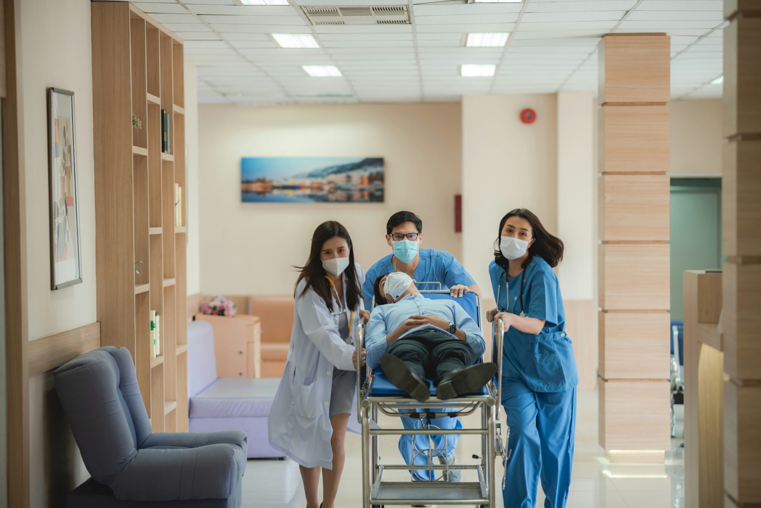 Medical team transporting a patient on a hospital stretcher during emergency care.